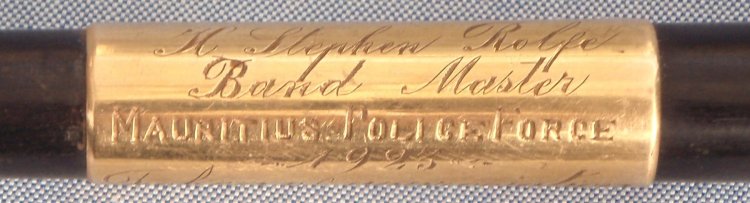 Part of the dedication inscribed on a gold band on the baton.